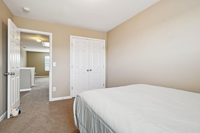 bedroom with a closet, baseboards, and carpet flooring