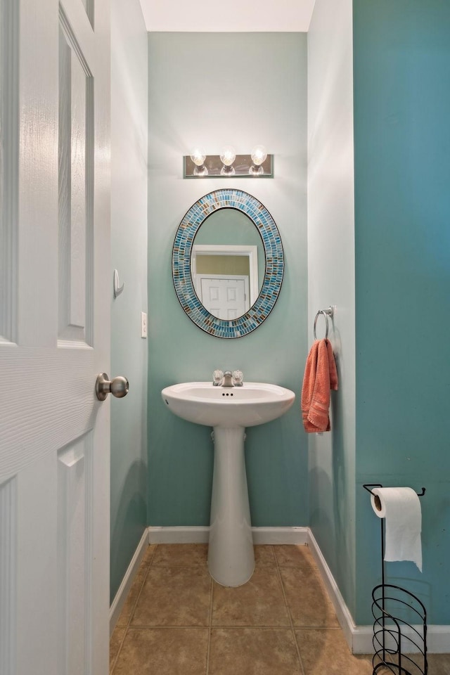 bathroom with baseboards and tile patterned floors