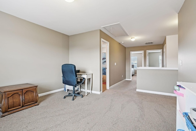 office featuring visible vents, light carpet, attic access, and baseboards