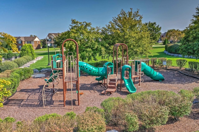 community jungle gym featuring a yard