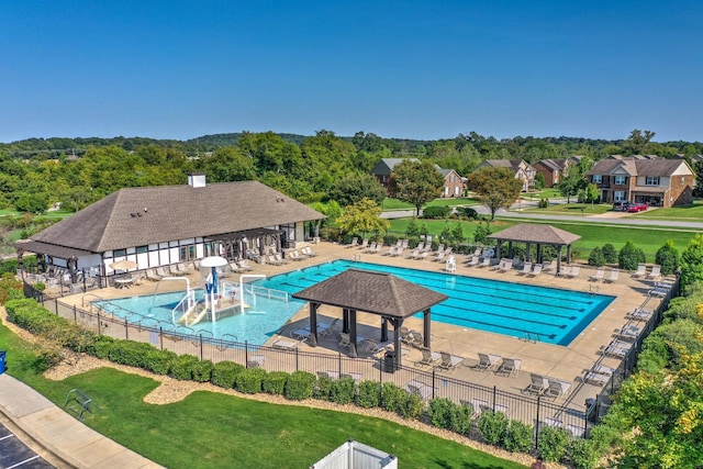 pool featuring a patio area, fence, a lawn, and a gazebo