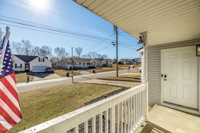 view of yard with covered porch and a residential view