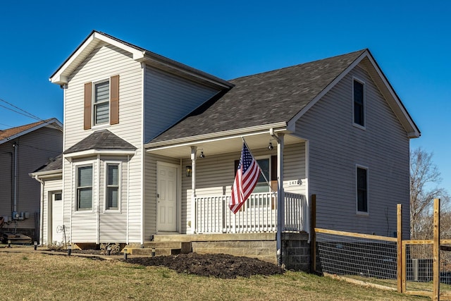 view of front of home with a porch and a shingled roof