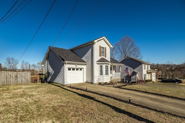 view of side of home featuring driveway, a lawn, an attached garage, and fence