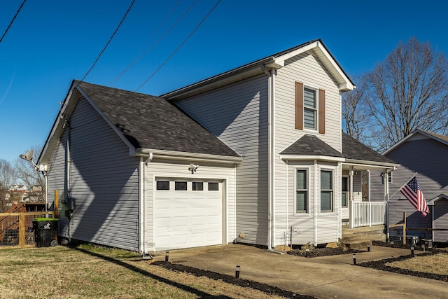 view of side of home featuring a garage, driveway, and roof with shingles