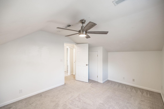 bonus room with lofted ceiling, baseboards, and light colored carpet