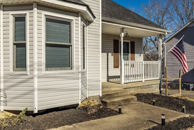 view of property exterior with covered porch and roof with shingles