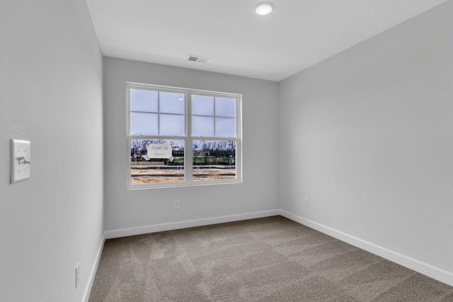 empty room with light carpet, visible vents, and baseboards