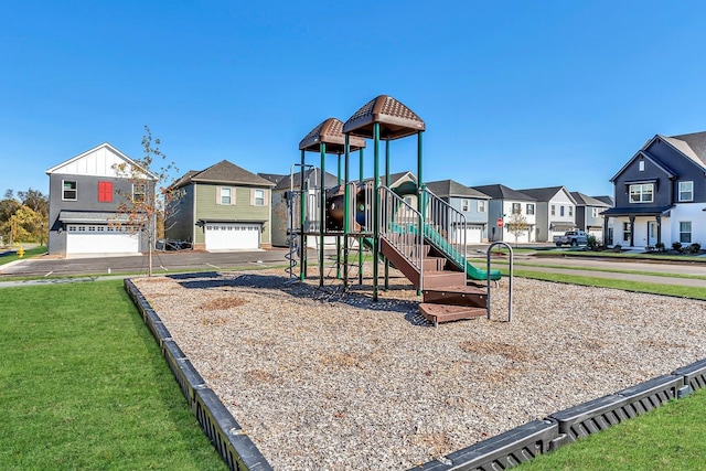 community play area featuring a residential view and a yard