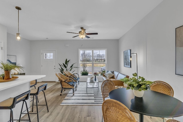 living area featuring light wood-style floors and a ceiling fan