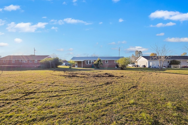 view of yard featuring a residential view and fence