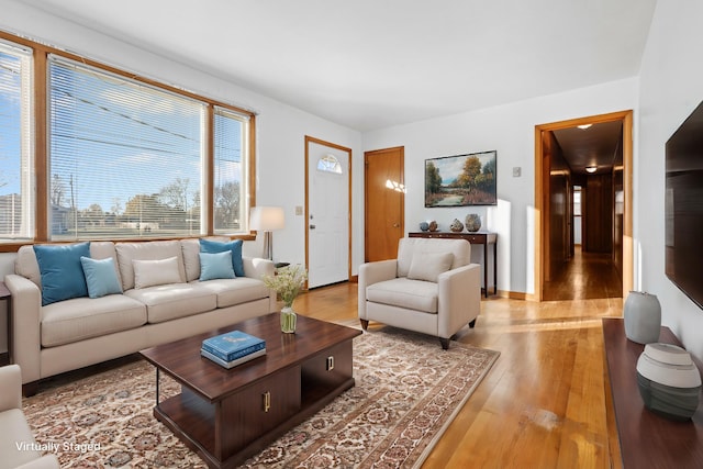 living area with light wood-style flooring and baseboards