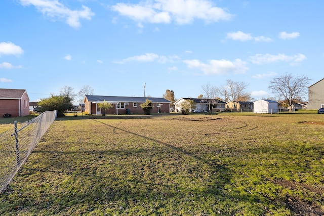 exterior space featuring a residential view, fence, and a front yard