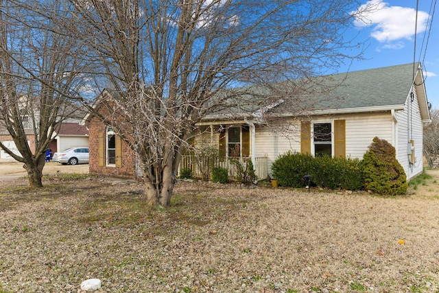 single story home with a shingled roof and covered porch