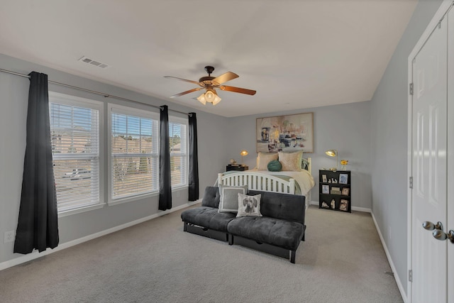 bedroom with light carpet, baseboards, visible vents, and ceiling fan