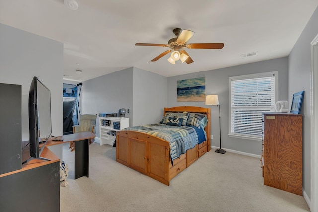 bedroom featuring ceiling fan, baseboards, visible vents, and light colored carpet