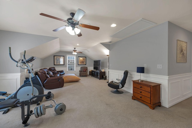workout room with light carpet, attic access, vaulted ceiling, and wainscoting