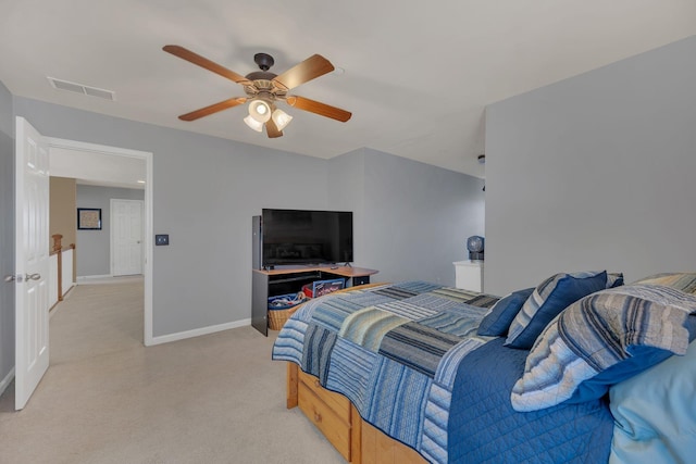 bedroom featuring baseboards, visible vents, a ceiling fan, and light colored carpet