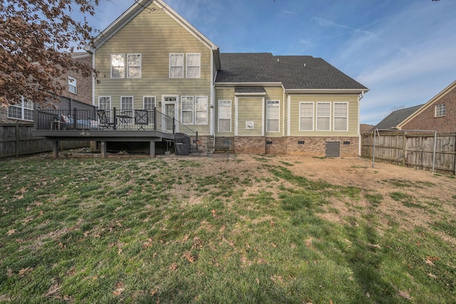 rear view of property featuring crawl space, a fenced backyard, a deck, and a yard