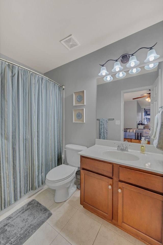 bathroom with curtained shower, visible vents, toilet, vanity, and tile patterned flooring