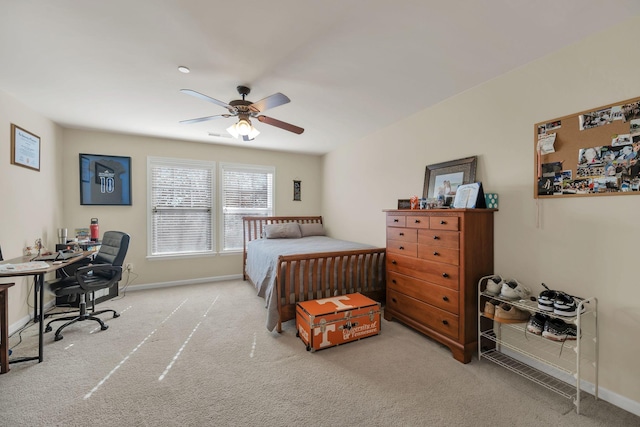 bedroom with light carpet, ceiling fan, and baseboards