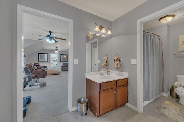 full bathroom featuring toilet, vanity, baseboards, vaulted ceiling, and a shower with curtain