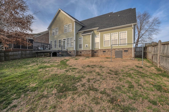 back of house featuring crawl space, a fenced backyard, a wooden deck, and a yard
