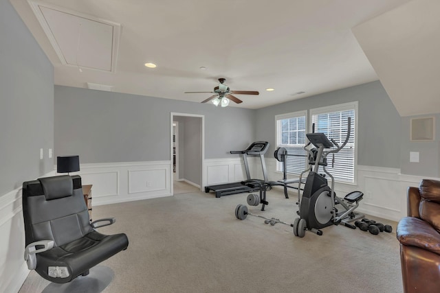 exercise room with light carpet, a wainscoted wall, attic access, and recessed lighting