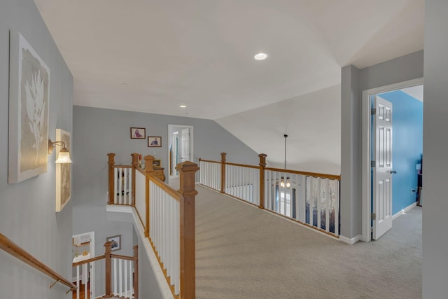 hallway featuring carpet floors, recessed lighting, vaulted ceiling, an upstairs landing, and baseboards