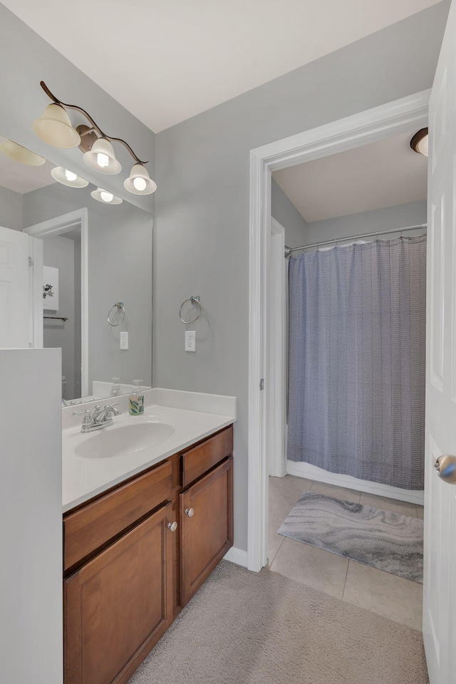 full bathroom featuring a shower with shower curtain, tile patterned flooring, and vanity