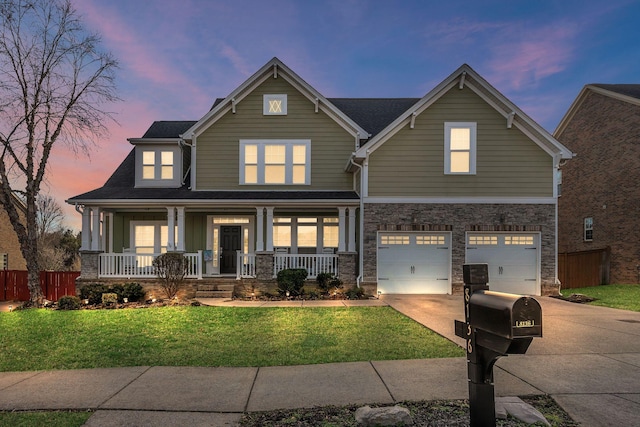 craftsman-style house with an attached garage, covered porch, fence, concrete driveway, and a lawn