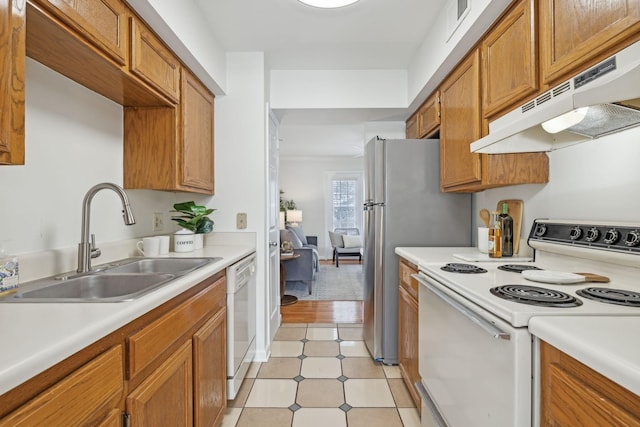 107 Sylvan Glen Ct, Nashville, TN 37209 - kitchen with light countertops, brown cabinetry, a sink, white appliances, and under cabinet range hood