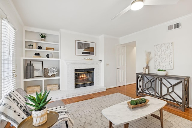 107 Sylvan Glen Ct, Nashville, TN 37209 - living area with ornamental molding, a fireplace, wood finished floors, and visible vents
