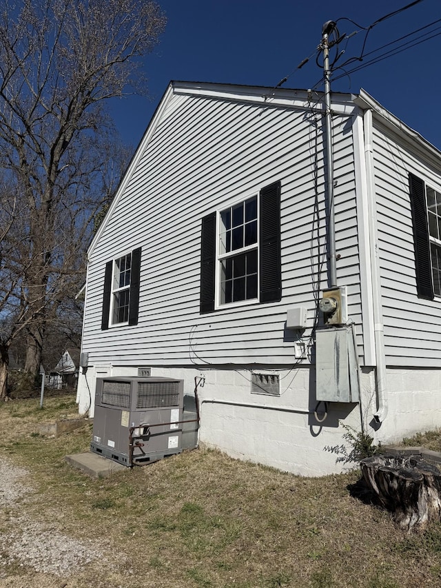 view of side of property with crawl space and central air condition unit