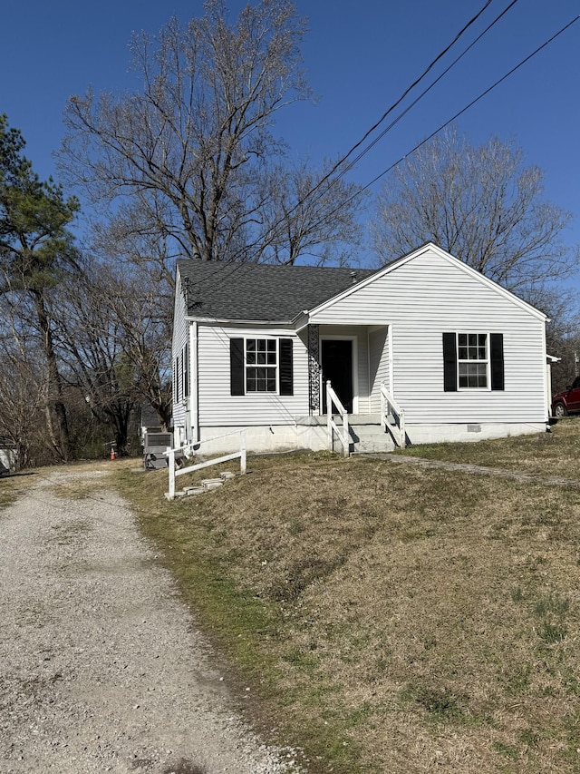 view of front facade featuring driveway, roof with shingles, and crawl space