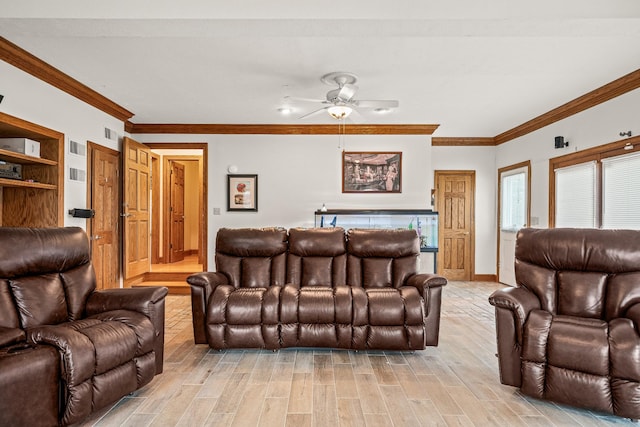 living area featuring light wood finished floors, a ceiling fan, visible vents, and crown molding