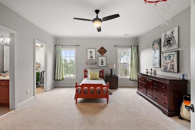 carpeted bedroom featuring ensuite bathroom, crown molding, baseboards, and ceiling fan