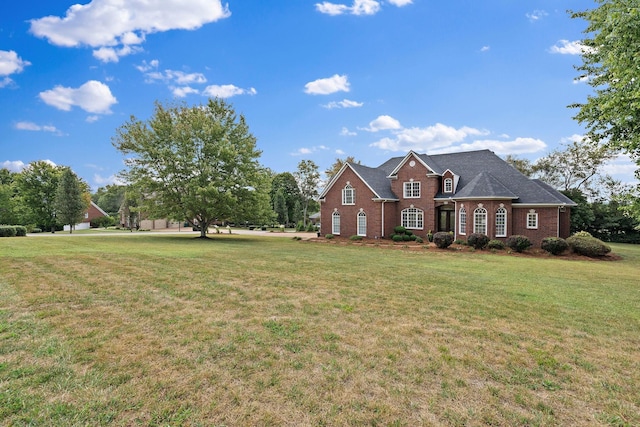 view of front of house featuring brick siding and a front yard