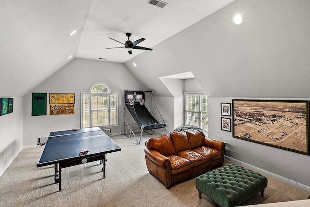 recreation room featuring baseboards, visible vents, a ceiling fan, lofted ceiling, and carpet floors