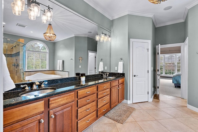 bathroom featuring a stall shower, visible vents, tile patterned floors, crown molding, and a sink