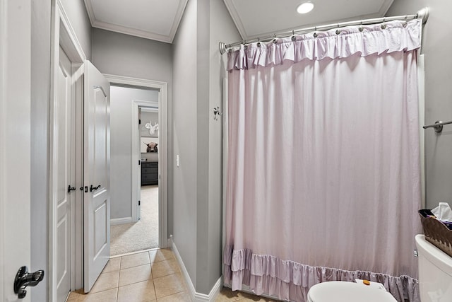 bathroom with ornamental molding, tile patterned flooring, toilet, and baseboards