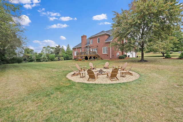 view of yard featuring a fire pit and a wooden deck