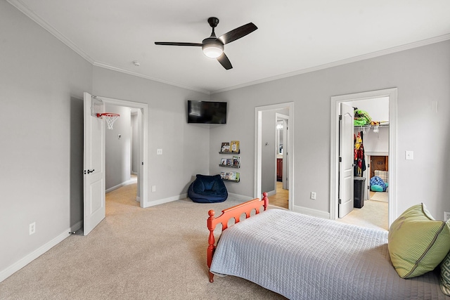 bedroom featuring baseboards, light colored carpet, ceiling fan, a spacious closet, and crown molding