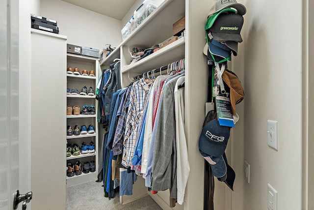 walk in closet featuring carpet flooring