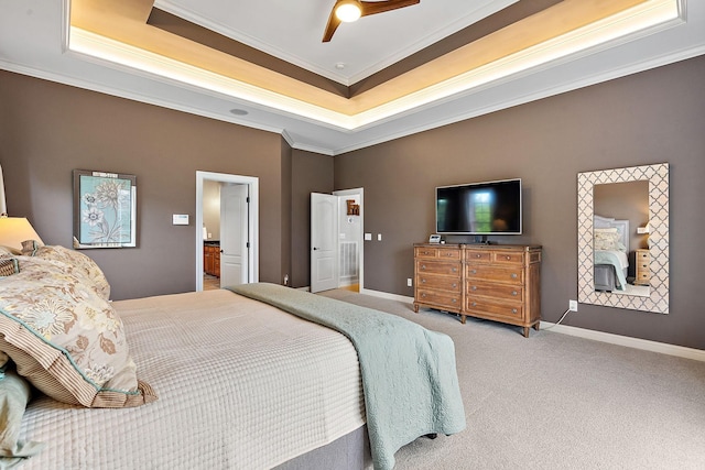 carpeted bedroom featuring baseboards, ornamental molding, and a raised ceiling