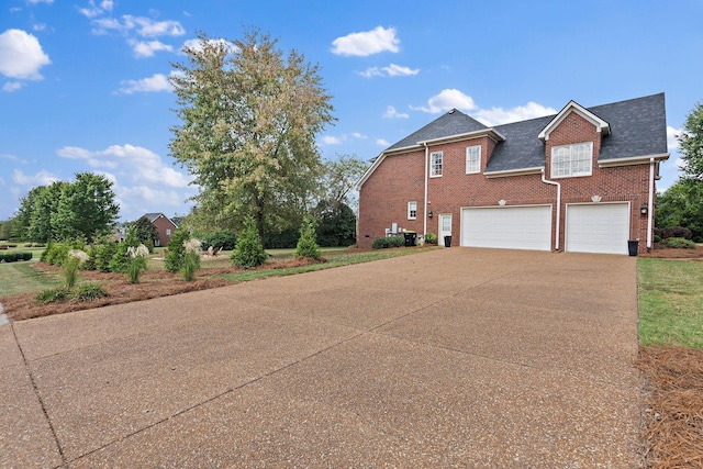 view of home's exterior with driveway, roof with shingles, an attached garage, central air condition unit, and brick siding