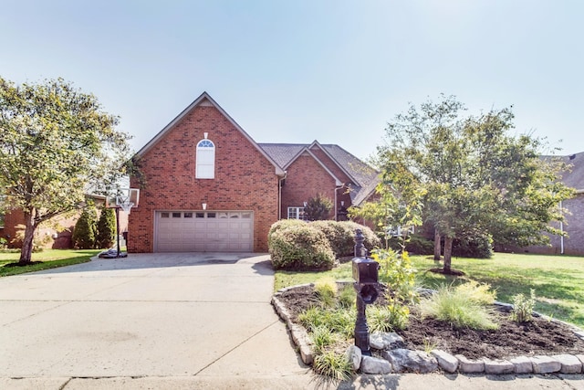 traditional home with an attached garage, a front yard, concrete driveway, and brick siding