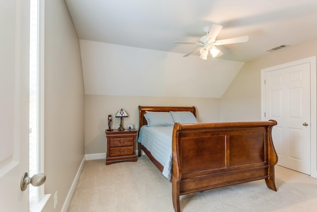 bedroom with light carpet, baseboards, visible vents, a ceiling fan, and lofted ceiling