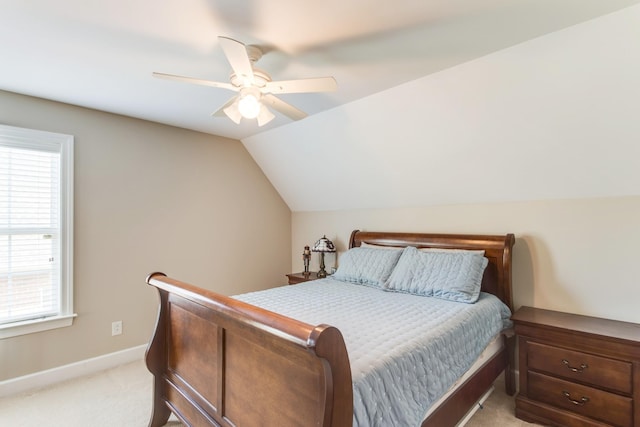 bedroom with lofted ceiling, light colored carpet, ceiling fan, and baseboards