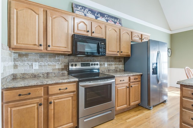 kitchen with light stone counters, tasteful backsplash, appliances with stainless steel finishes, vaulted ceiling, and light wood-type flooring